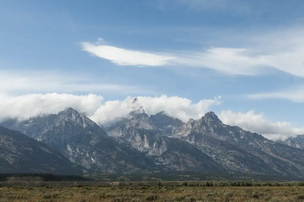 Clouds rolling over mountain peaks in Grand Teton National Park