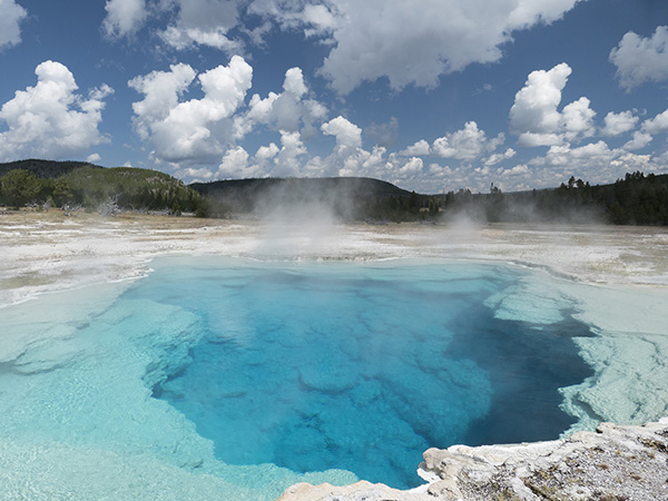 Blue colored geothermal pool in Yellowstone National Park