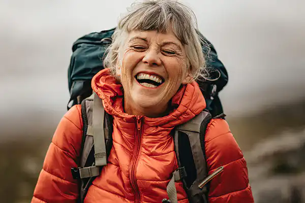 Smiling hiker with wearing a backpack